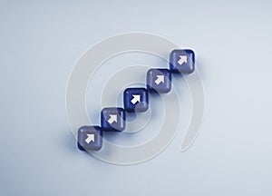 White rising arrows, increase symbol on blue cube blocks stacking as a chart step stair on a light blue background, top view.