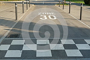 White road marking on the road of 30 km/h zone as a form of speed management used across areas of urban roads.