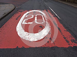 White road sign 20 mph speed limit painted onto the road photo