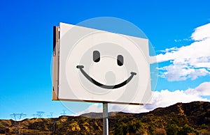 White roadside smiley billboard