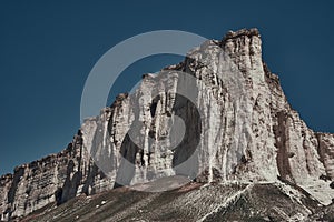 White rock mountain on a background of blue sky