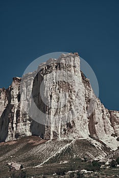 White rock mountain on a background of blue sky