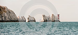 White rock mountains in UK. High angle view of the Needles in the Isle of Wight. Light house in the sea