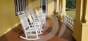 White Rocking Chairs on Yellow Porch