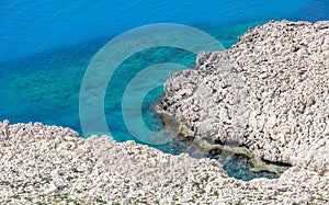 White rocks and blue sea, minimalistic sea background and textur
