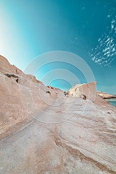 White rocks of Sarakiniko beach, Aegean sea, Milos island , Greece. Lonely stranger, empty cliffs, summer sunshine