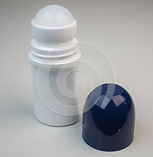 White roll on deodorant bottle with blue cap