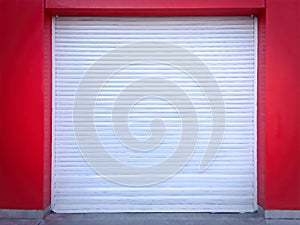 White Roll-up Door on Red Wall of the Garage