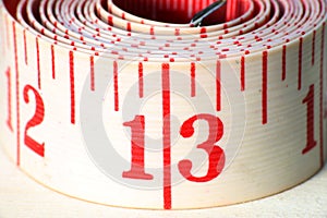 A white rolled measuring tape showing centimeters