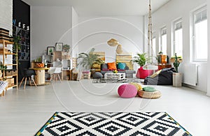 White room with colorful pouf