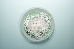 White rope on a round plate. Spaghetti concept