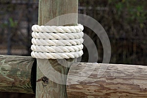 White rope wrapped around dock pier post