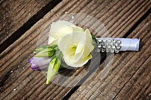 White rose and tulip Groom's boutonniere closeup