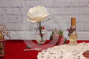 White Rose in Vase Next to Vintage Rhinestone Rose and Perfume Bottle