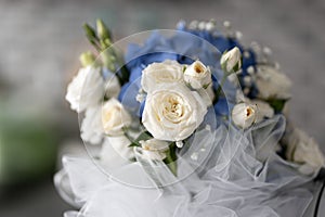 white roses and blue orthensia flower wedding bouquet detail photo