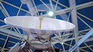 White rotating satellite dish antenna using to receive or transmit information