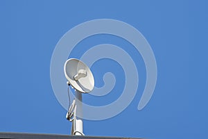 White round antenna in blue sky