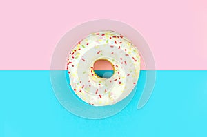 White round doughnut on pink and blue background