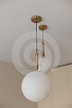 a white round light bulb in a modern interior of a house room