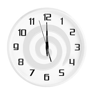 White round office clock showing twelve o`clock isolated on white background.