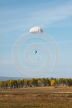 White round parachute on the background of the autumn landscape. photo