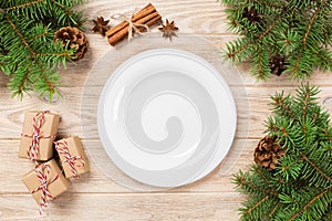 White Round Plate on white wooden table background. Perspective view