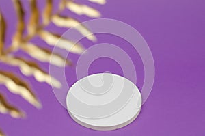 White round podium for advertising cosmetic products on a purple background. Empty display stand for packaging