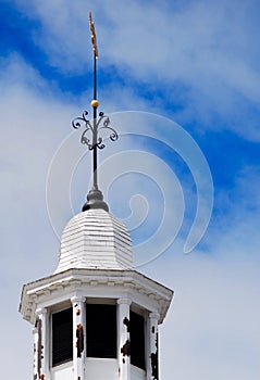 White, round steeple with gold fish weathervane on top