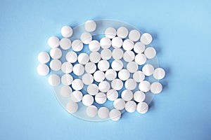 White round tablets, supplements on a blue background. Magnesium vitamins