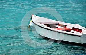 White row boat in clear blue water