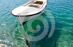White row boat in crystal clear waters