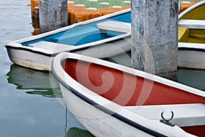 White rowboat moored near shore in the lake