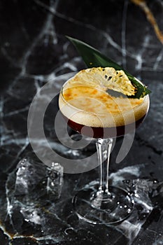 White russian cocktail, trendy alcoholic drink with vodka, coffee liqueur, cream and ice on black marble background