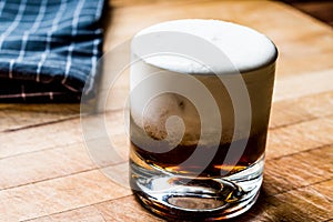 White Russian Cocktail on wooden surface.
