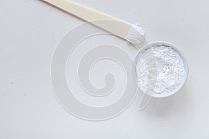 White rustic background with cream and alginate mask. Top view