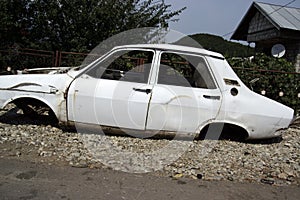 White rusty car before scrapping