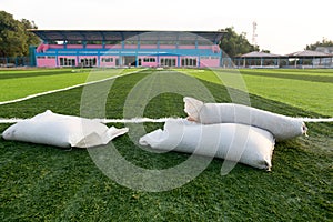 White sack on new soccer field with light and dark green artificial grass