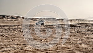 White safari jeep car in sand dune