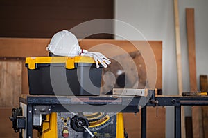 White safety helmets blueprints on the engineering desks. Hard safety wear helmet hat on desks at construction site