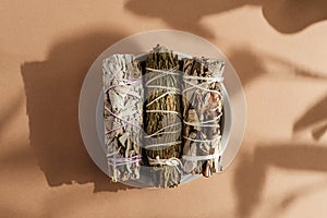 White sage, cedar, yerba santa tied in a bunch on a concrete plate.