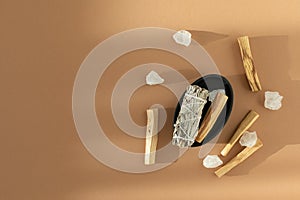 White sage, natural crystals and Palo Santo sticks incense set on beige background. Healthy lifestyle, good energy, aromatherapy