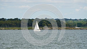 A white sail boat on the water at Grapevine lake Texas.