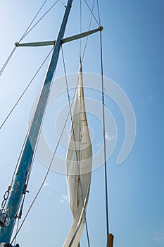 White sail of a sailing boat against sky. Sails of river sailing