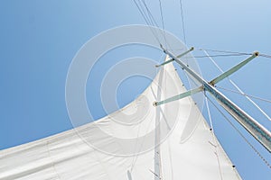 White sail of a sailing boat against sky. Sails of river sailing