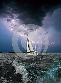 White sail.Storm sea.Black background.