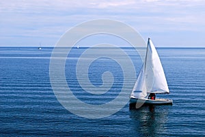 White Sailboat in the blue Ocean