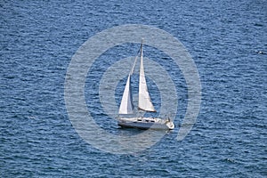 White sailboat on open blue sea in Portoroz, Slovenia