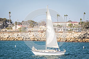 White Sailboat Sailing in a Harbor