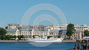 White sailing-motor ship `Young Baltic` near embankment of Vasilievsky Island and Neva river in the summe