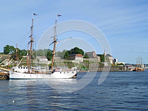 White sailing ship against Akershus Fortress, Olso Harbor